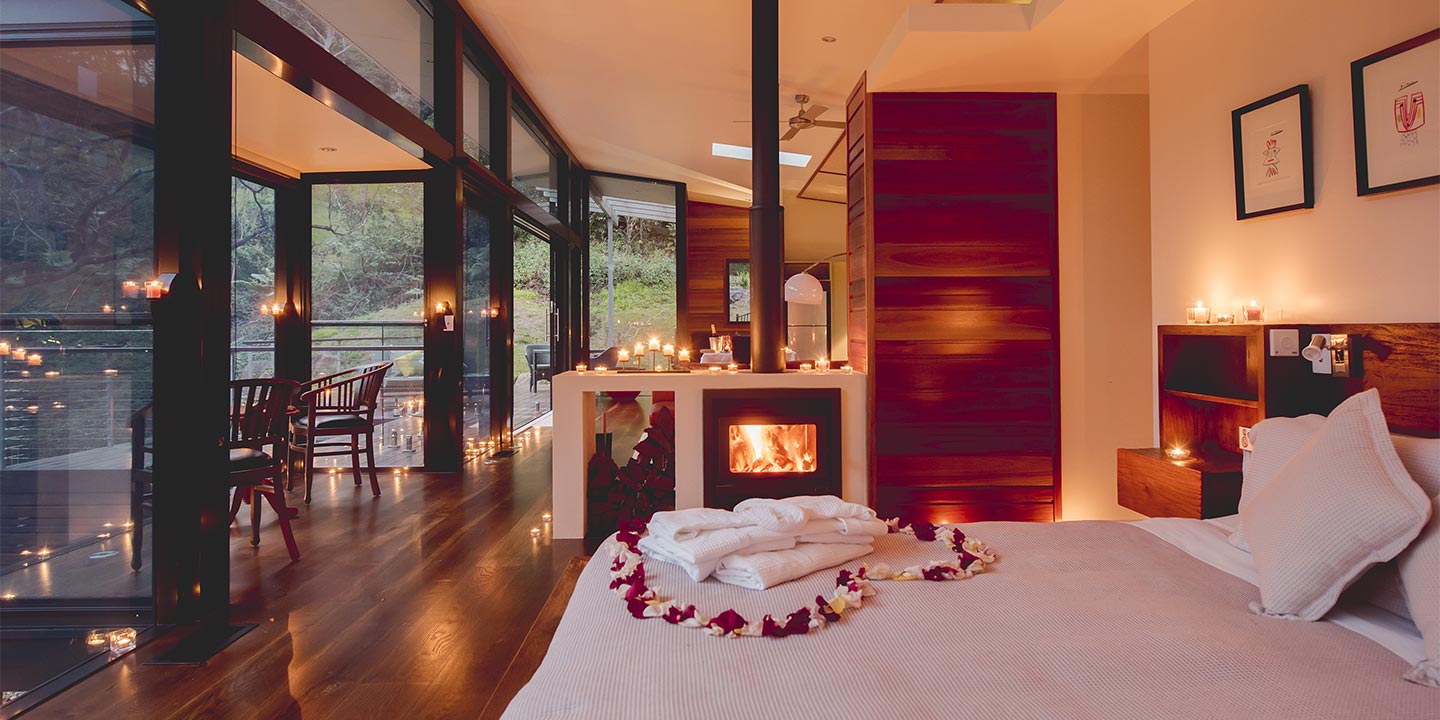 Luxury Mountain View Lodge at Crystal Creek Rainforest Retreat ready for romance with rose petal heart and fireplace