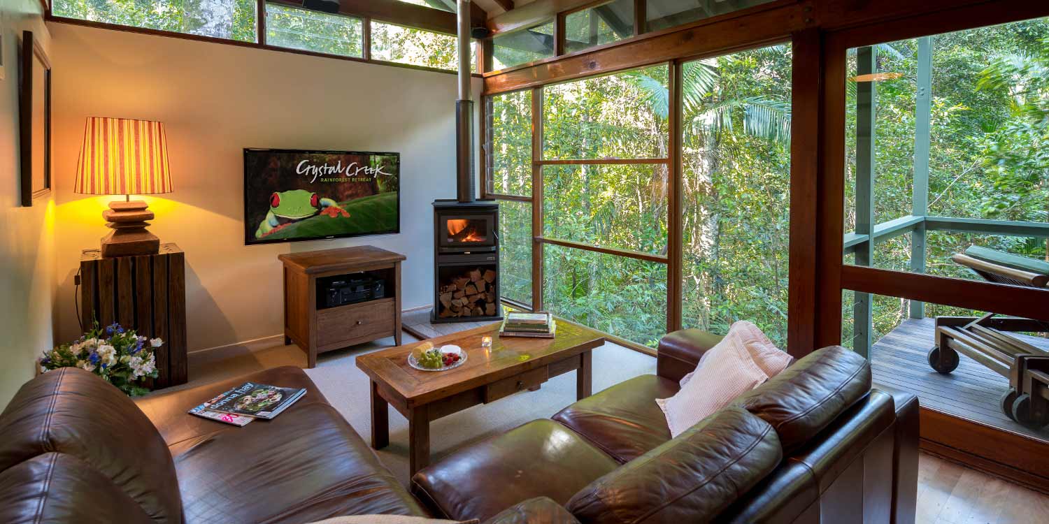 Creekside Spa Cabins have floor to ceiling rainforest views and a fireplace for winter in the lounge area
