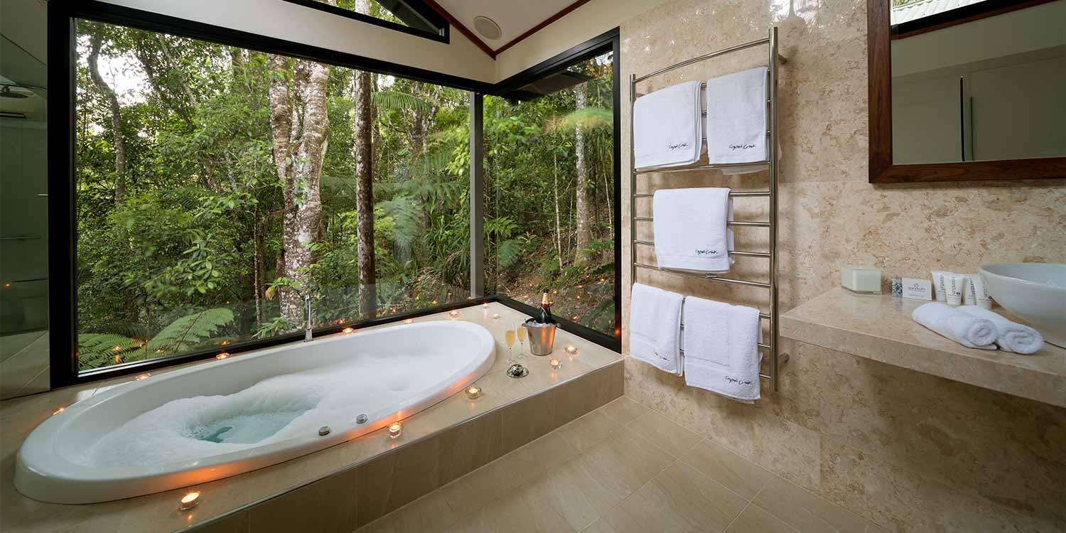 The Creekside Spa Cabins have full marble bathrooms with double spa baths with floor-to-ceiling rainforest views