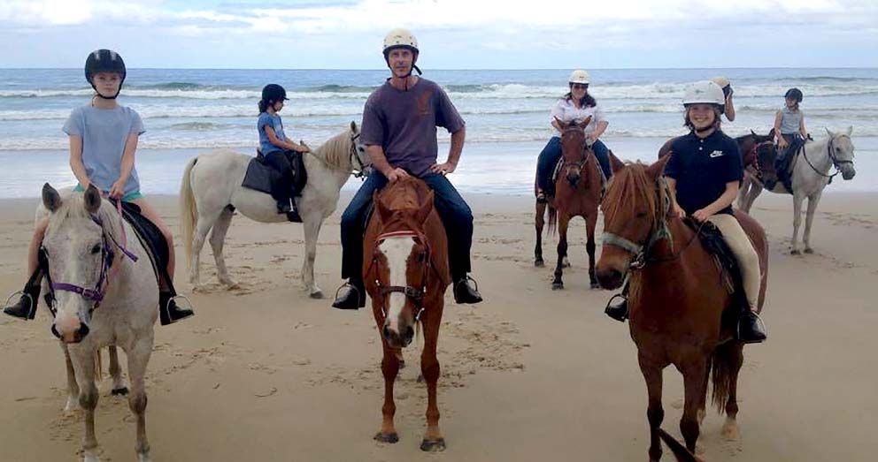 Ride horses along the beach at Byron Bay, just a day trip from Crystal Creek Rainforest Retreat